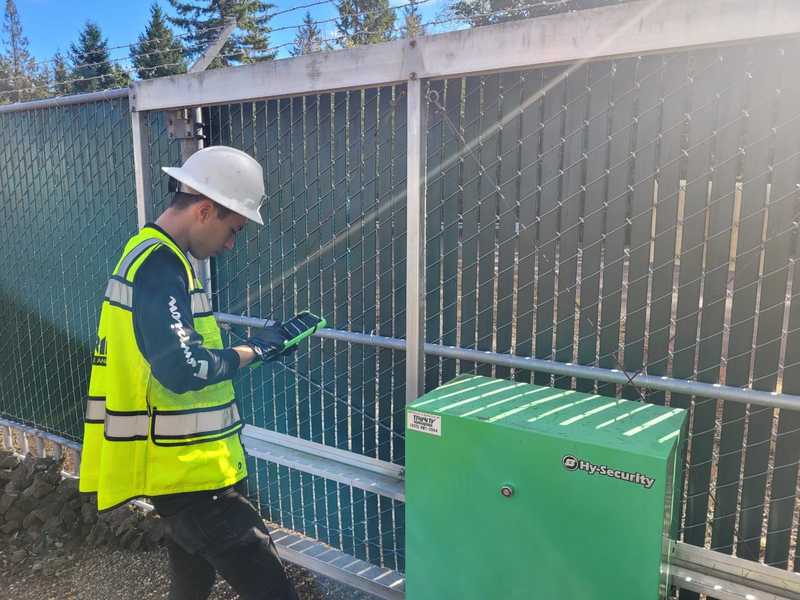 Trinity Gate technician using a tablet to service a slide gate operator