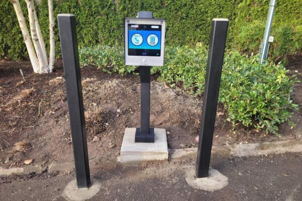 Call box on a pedestal between two black posts