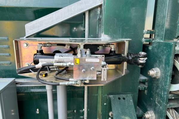 Hydraulic gate actuator mounted inside a green gate operator housing