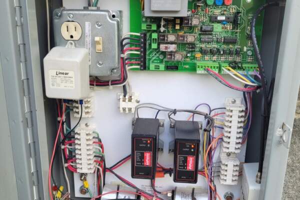 Gate operator control board and wiring inside an open operator housing